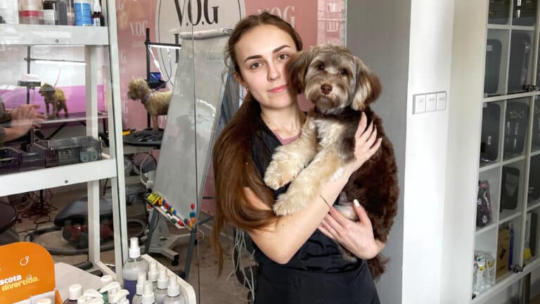 Грумер з мальтіпу обіймаються після процедур на вході в грумерську