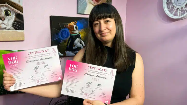 Дівчина з чубчиком показує рожеві сертифікати в рожевій кімнаті