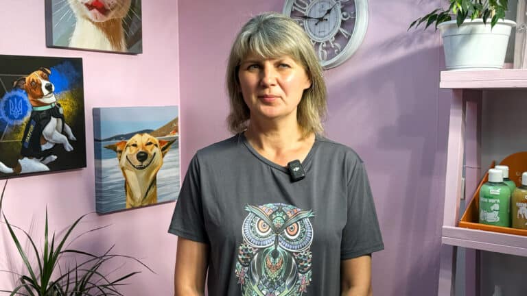 Жінка в сірій футболці з зображенням сови стоїть поруч з кометикою Burbur