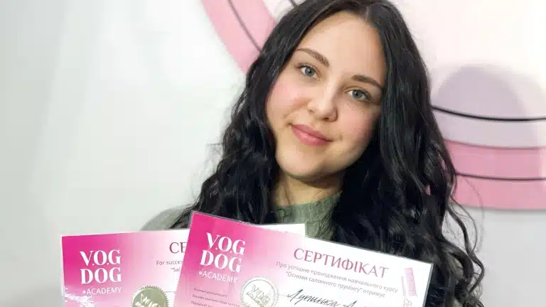 Волосся дівчини, що тримає сертифікати, в кудрях