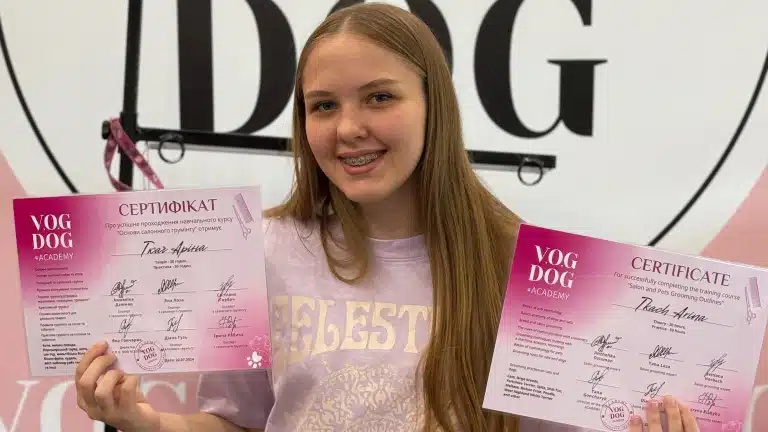 Дівчина з брекетами тримає в руках по сертифікату